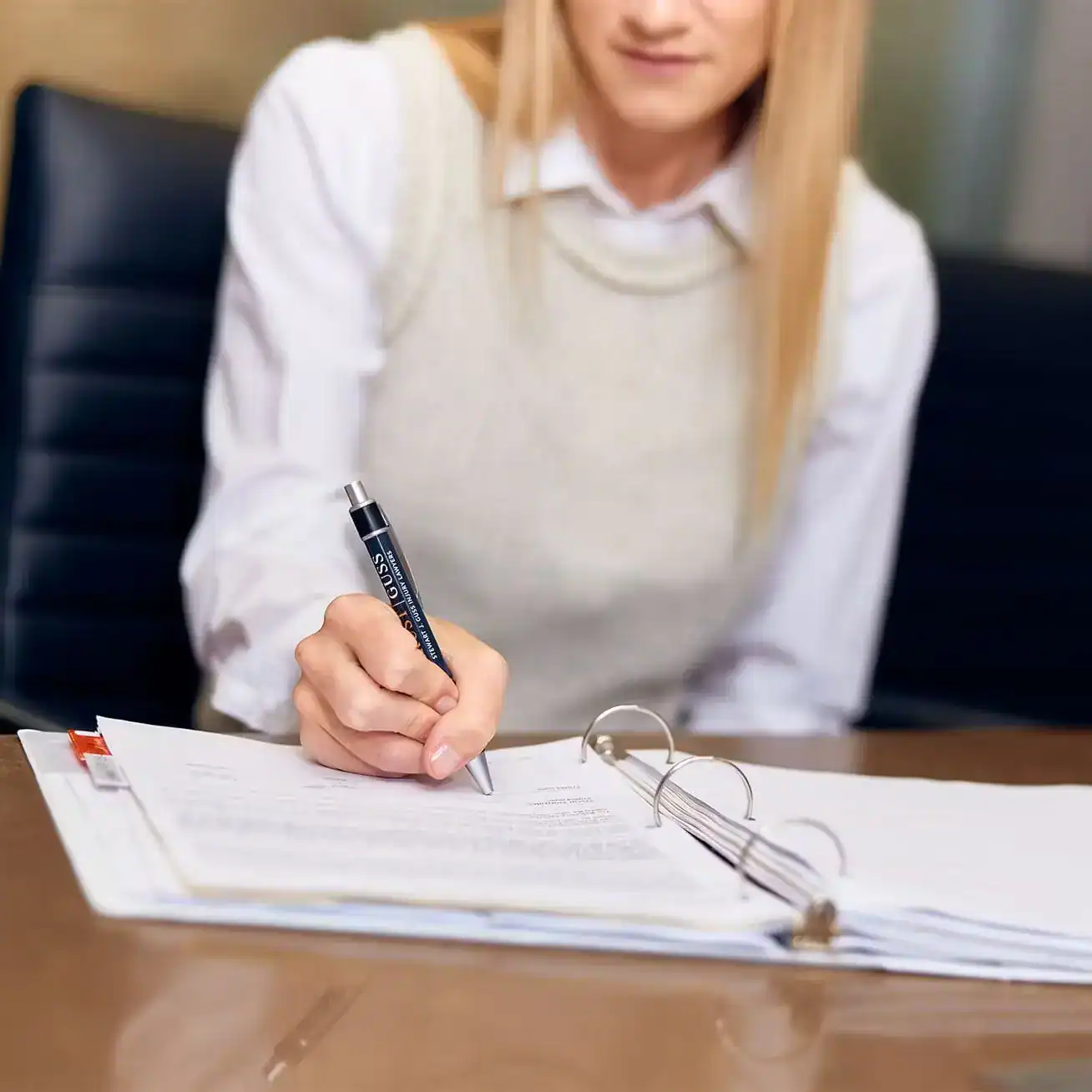 Lawyer reviewing and signing legal documents at office desk