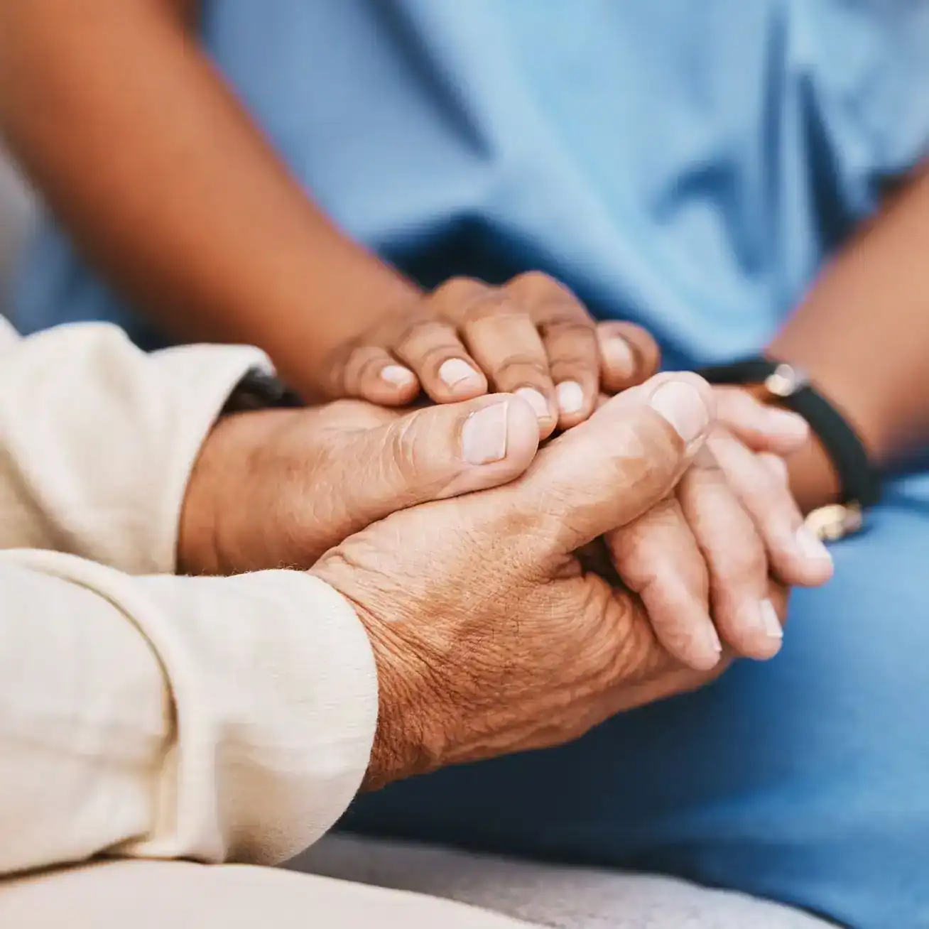 Compassionate personal injury support showing hands held in care and reassurance