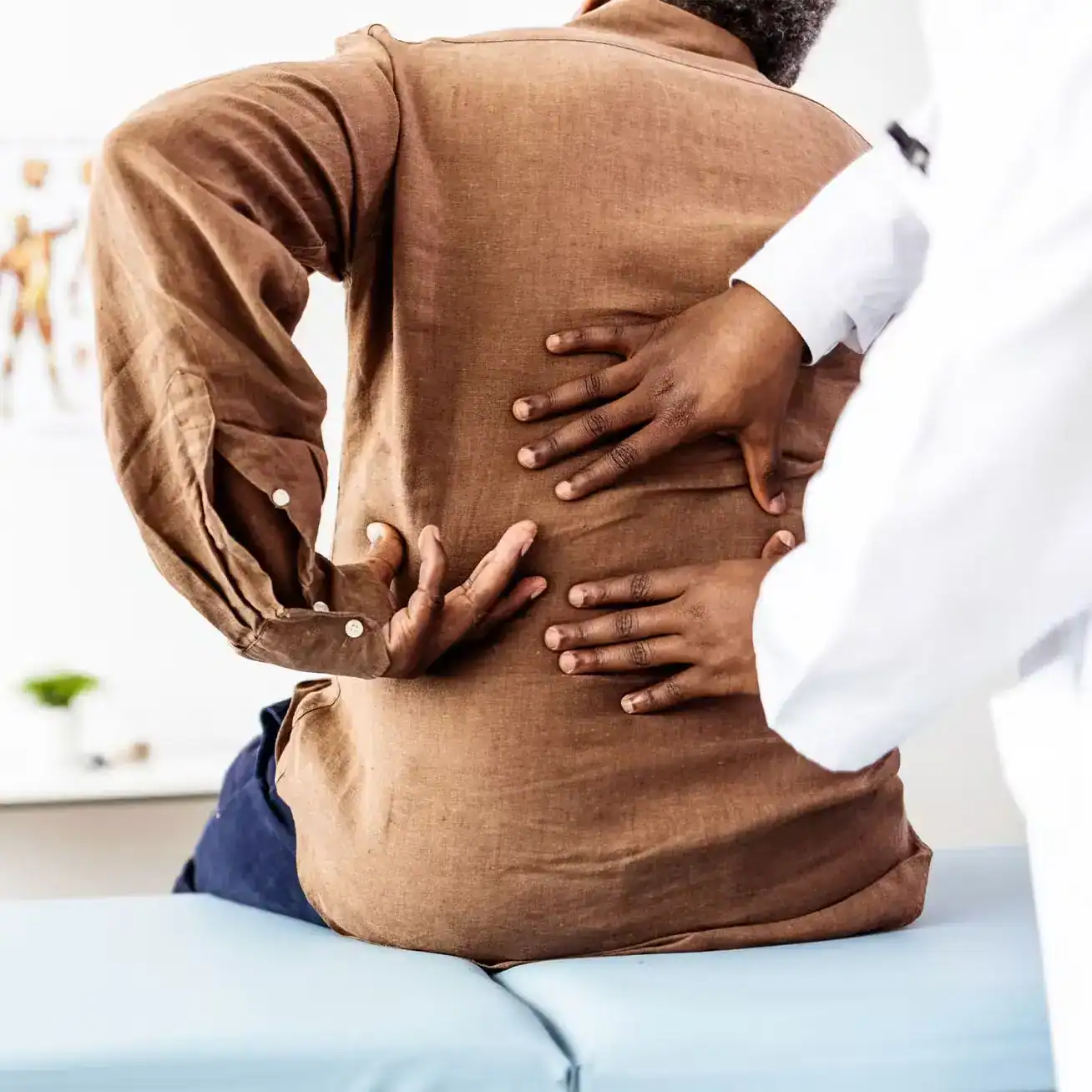 Doctor examining patient with back pain injury after car accident