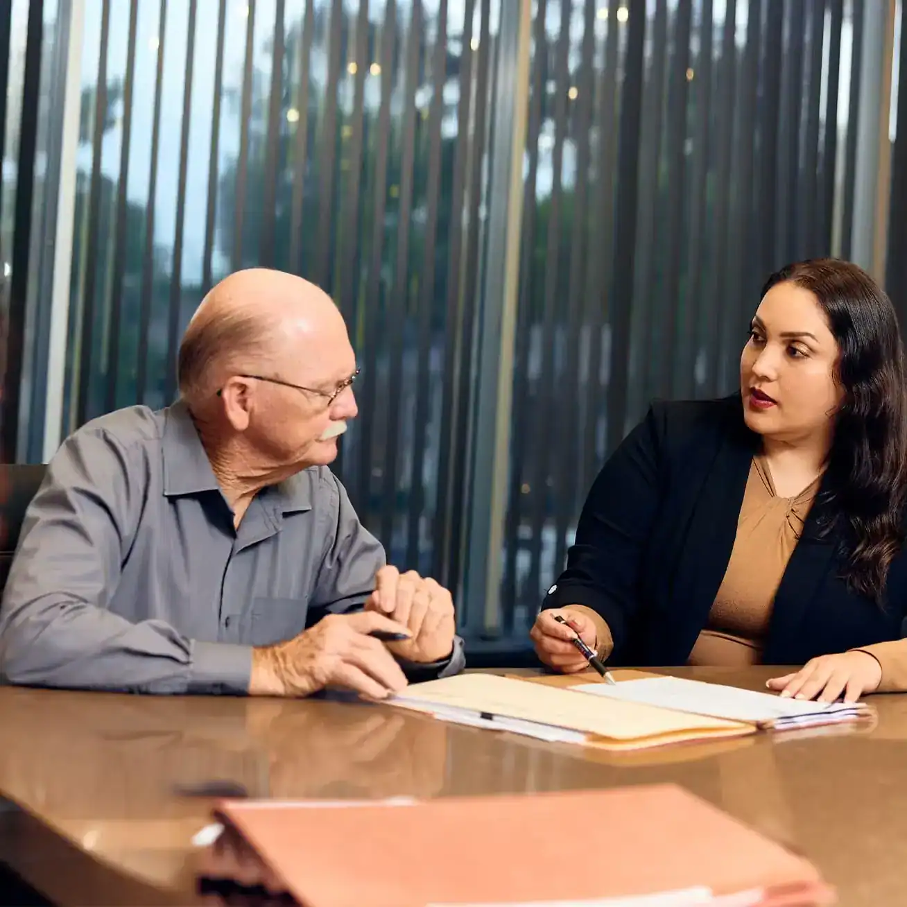 Elderly client meeting with Stewart J. Guss Injury Lawyers attorney in Houston to discuss personal injury case