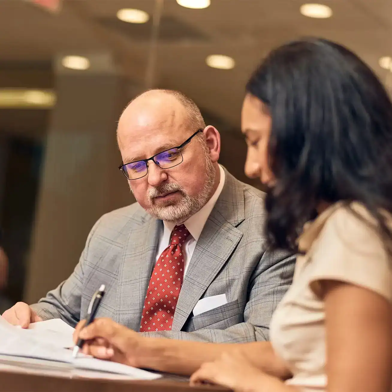 Attorney reviewing documents with client during personal injury case consultation