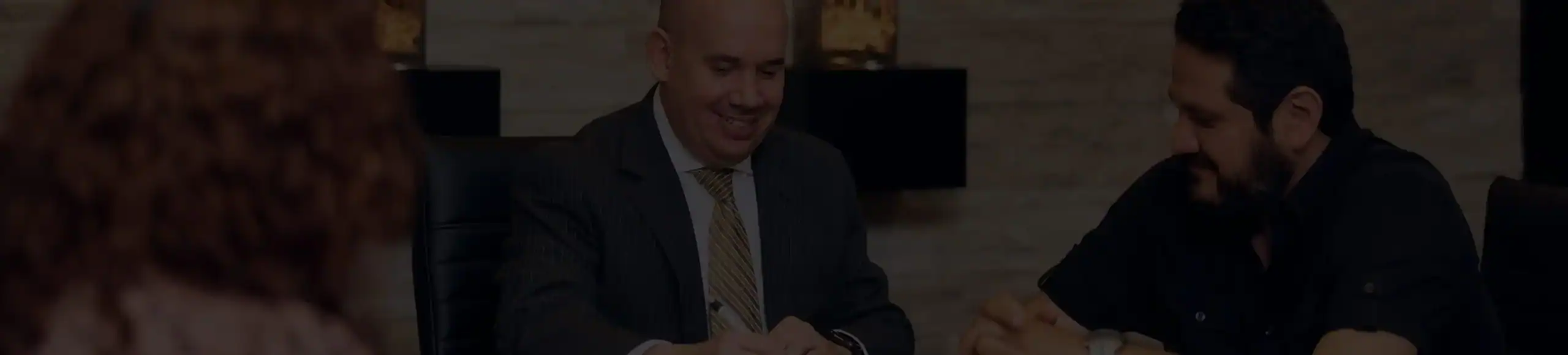 Personal injury lawyer meeting with clients during a legal consultation about accident case settlement