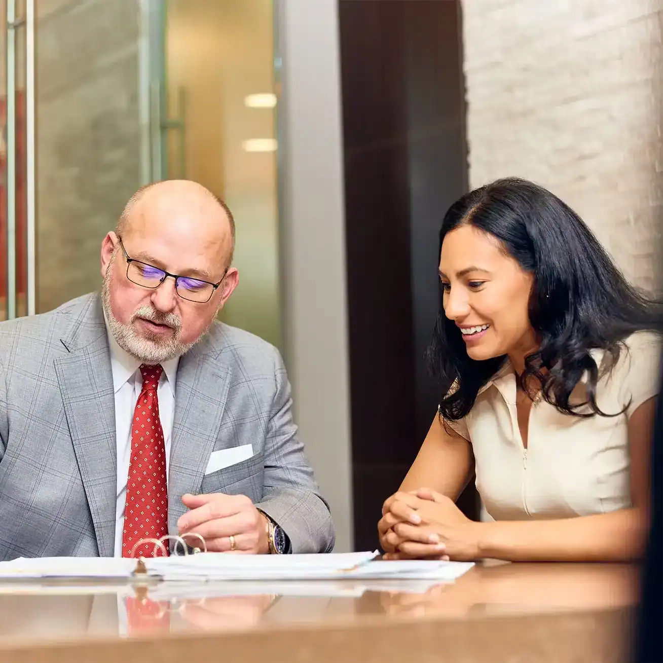 Personal injury lawyer reviewing legal documents with client during a consultation.