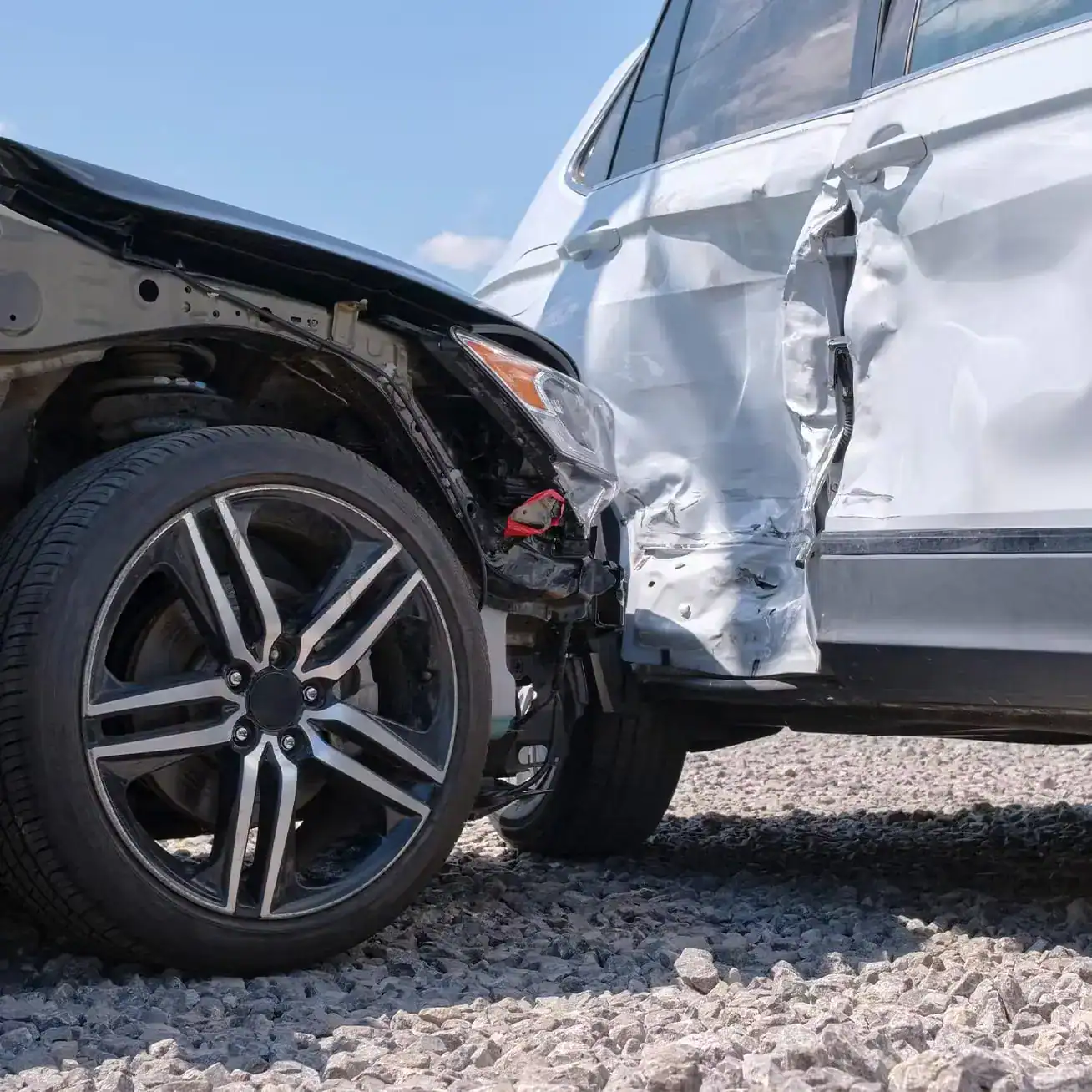 Severe side-impact car accident showing collision damage between two vehicles.