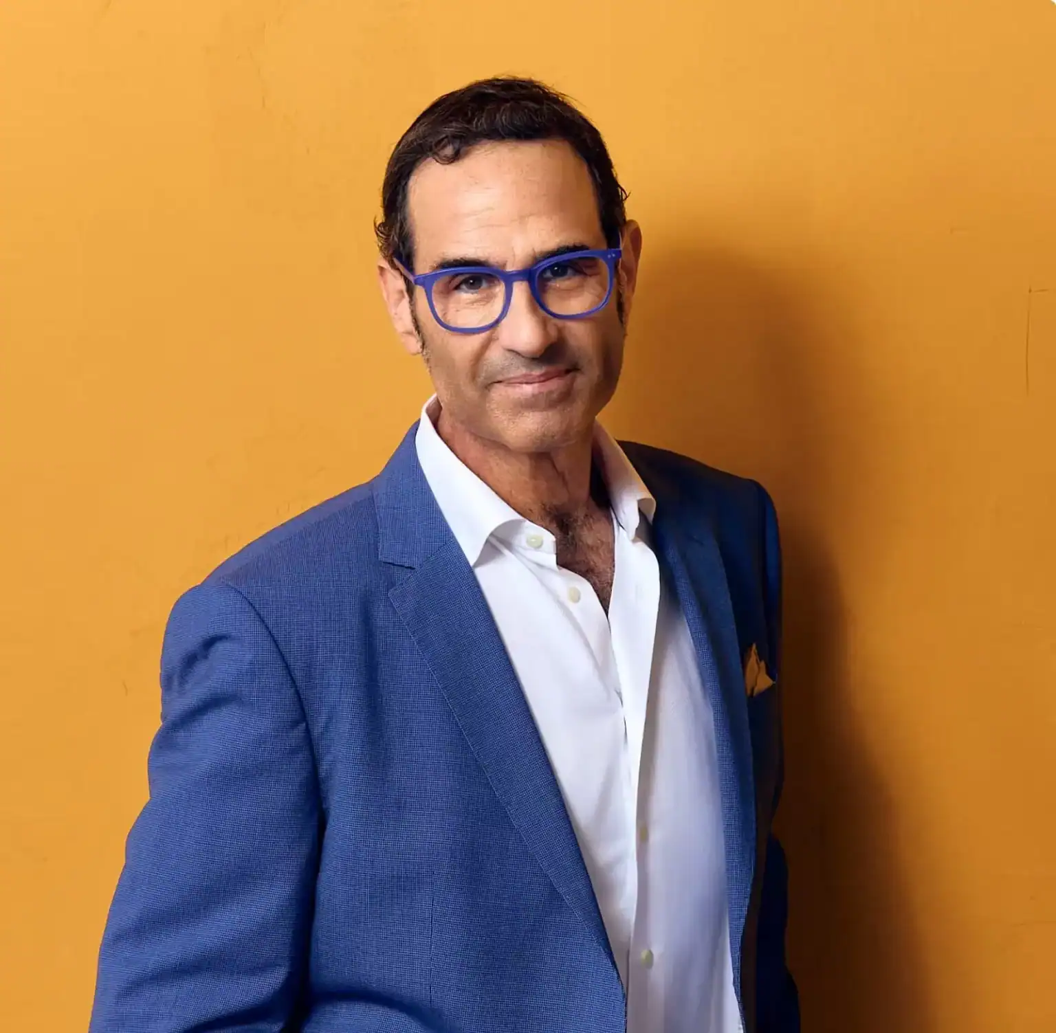 Stewart J. Guss Houston personal injury lawyer professional portrait in blue suit with orange background