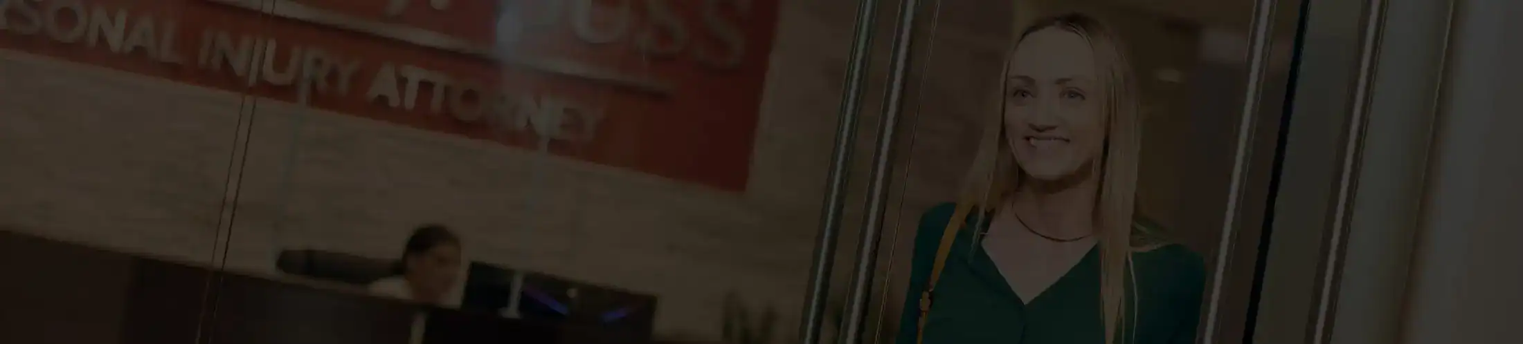 Client smiling while entering Stewart J. Guss Injury Lawyers office reception area