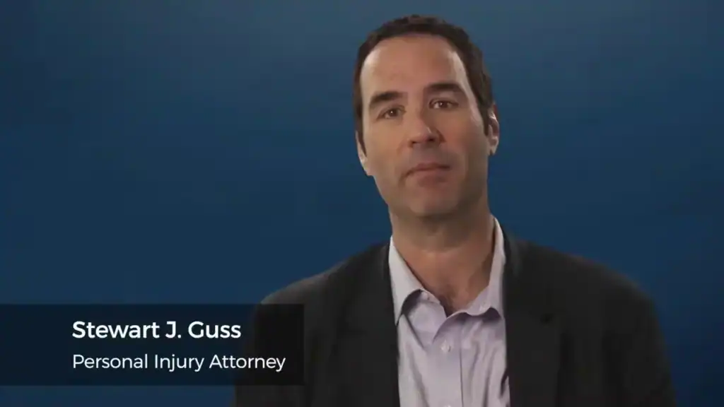 Stewart J. Guss Houston personal injury attorney professional portrait with blue background