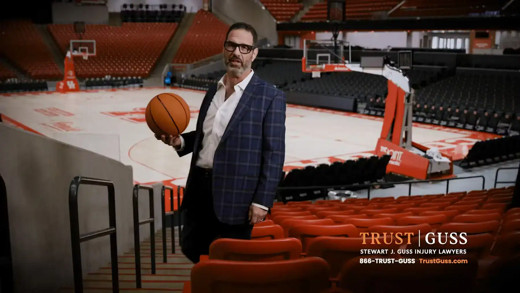 Stewart J. Guss Injury Lawyers sponsorship at Houston basketball arena with Trust Guss branding
