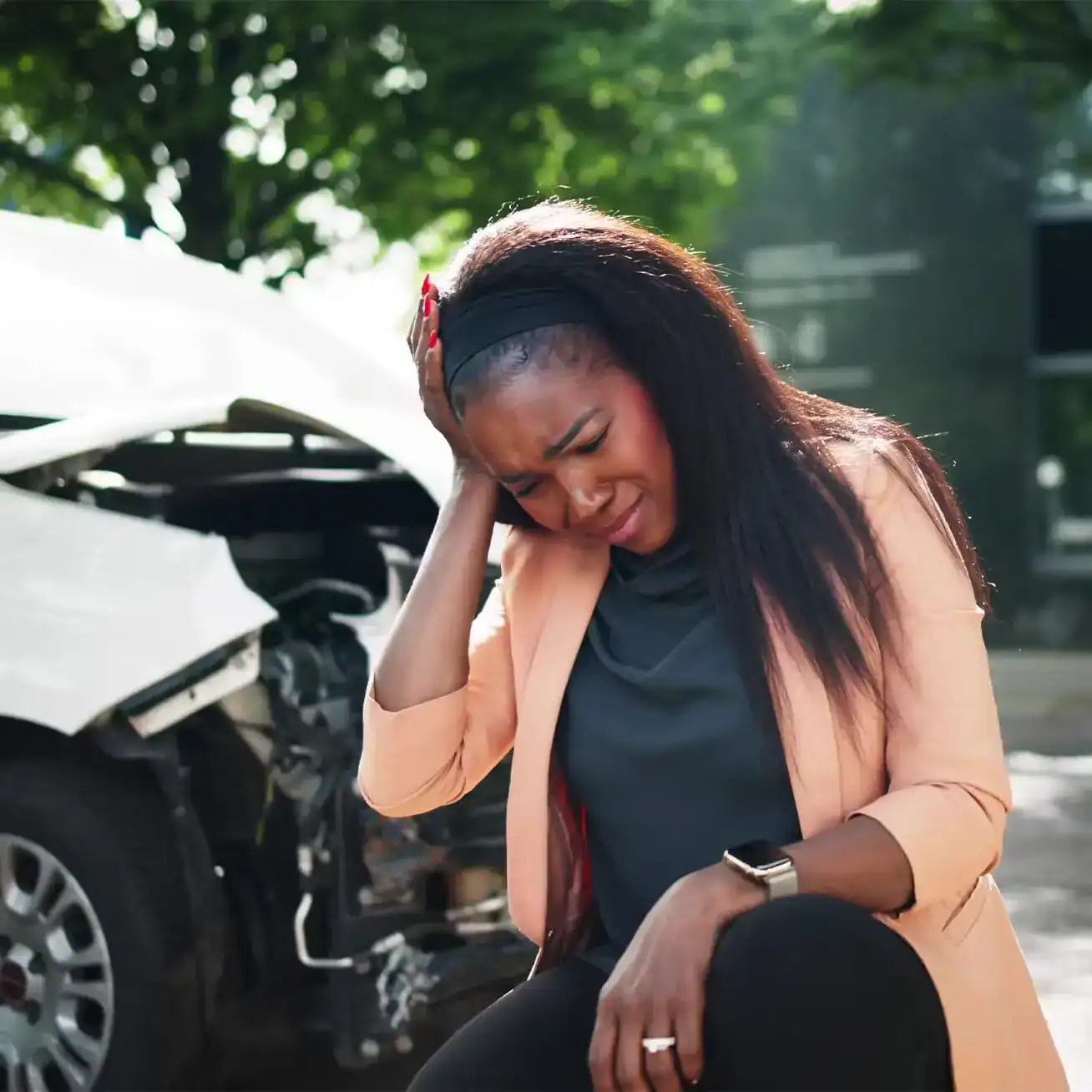 Injured woman holding her head after car accident, seeking personal injury lawyer help