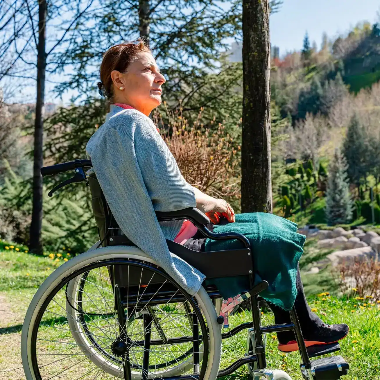 Injured woman in wheelchair outdoors during recovery after personal injury accident
