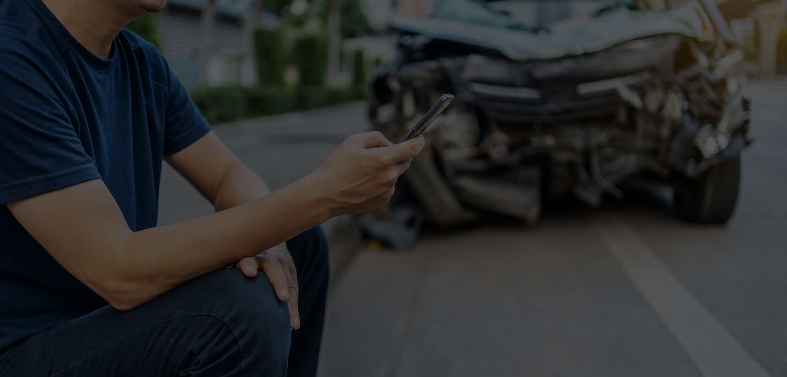 A Man Calling With Phone To His Insurance Agent After Traffic Accident With A Background Of The Crashed Car