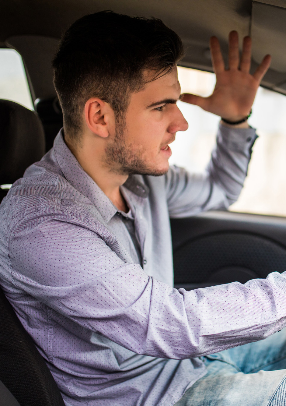 Side View Portrait Of An Angry Man In Casual Wear Driving Car