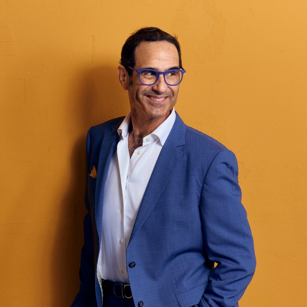 Stewart Standing In Front Of A Yellow Wall