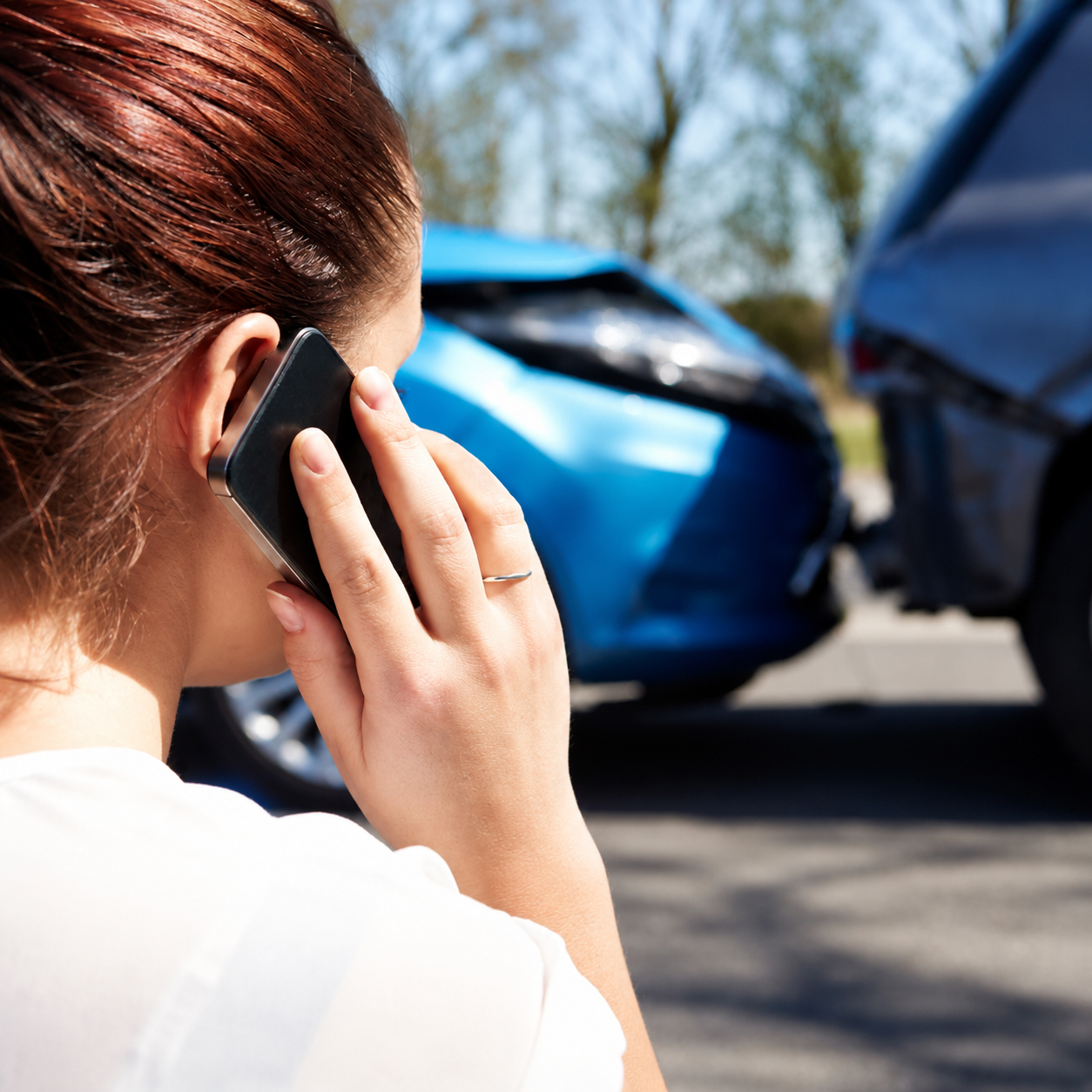 Female Driver Making Phone Call After Traffic Accident